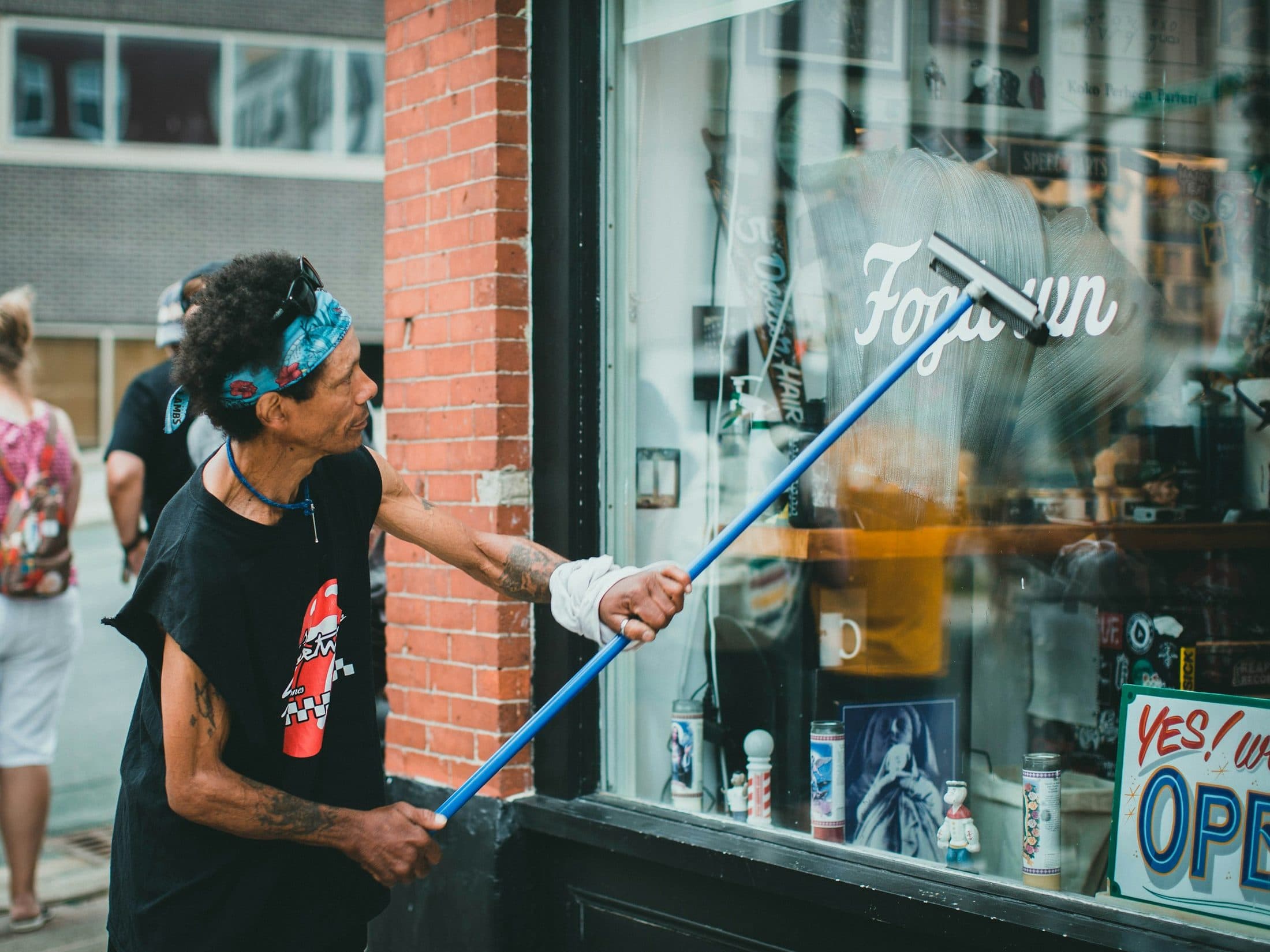 Shopfront being cleaned with a telescopic pole