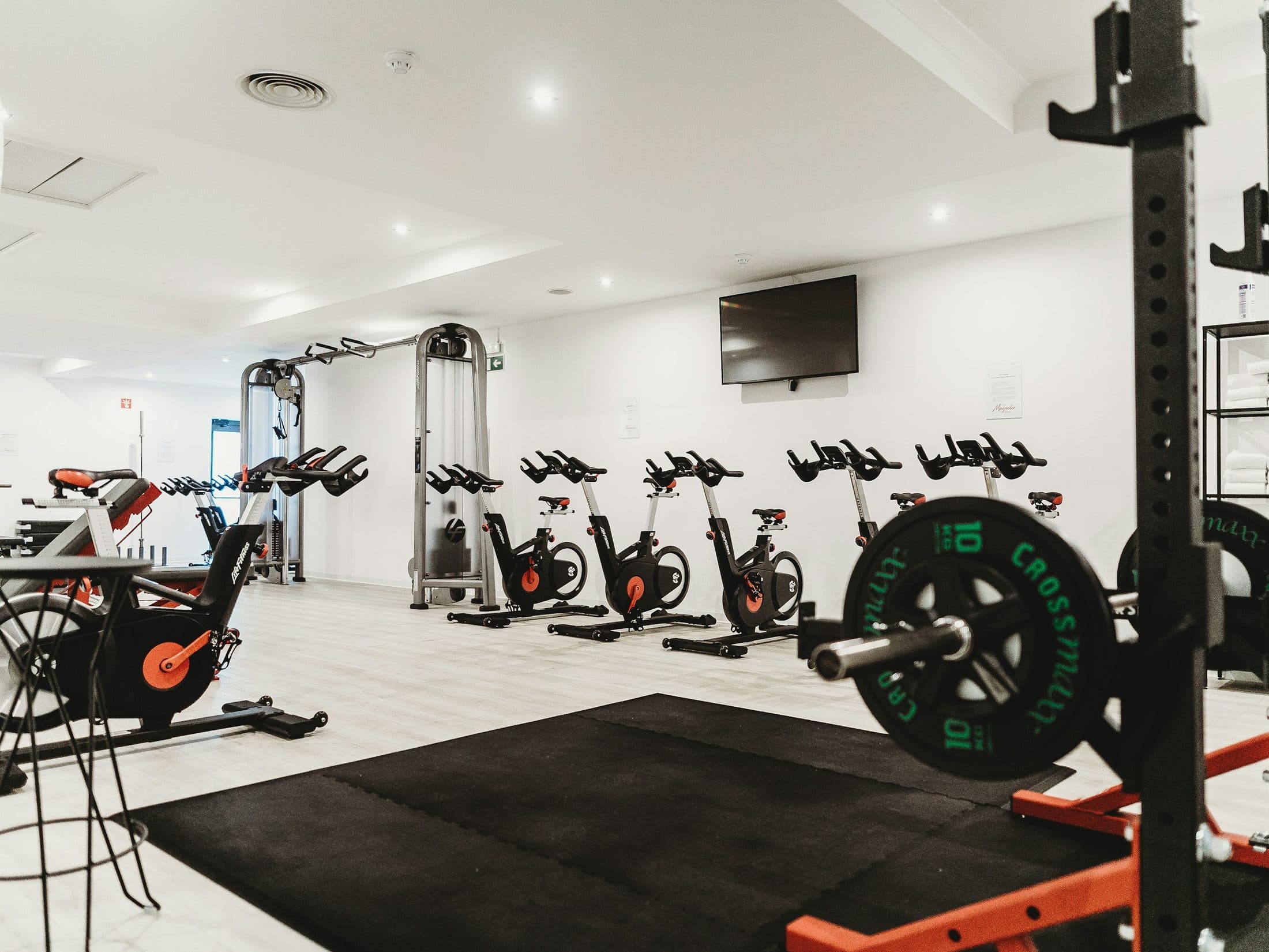 Empty gym with machines lined up before opening